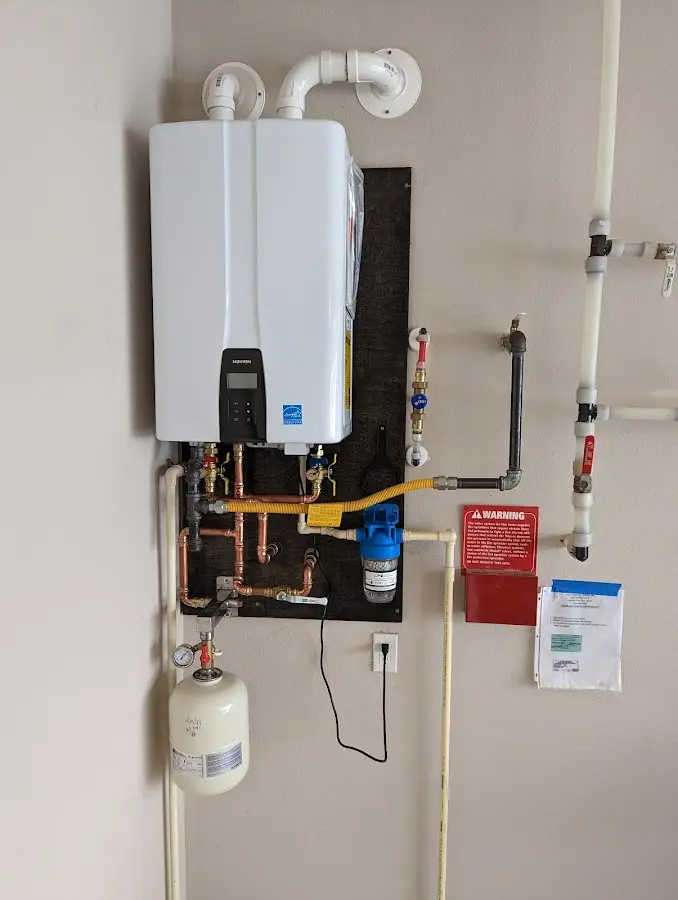 Professional plumber installing copper piping in a Hoffman Estates home